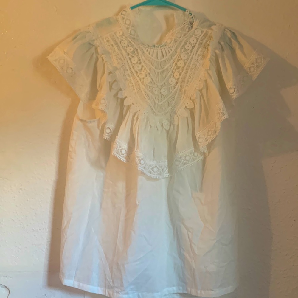 Large button back flowy white top.